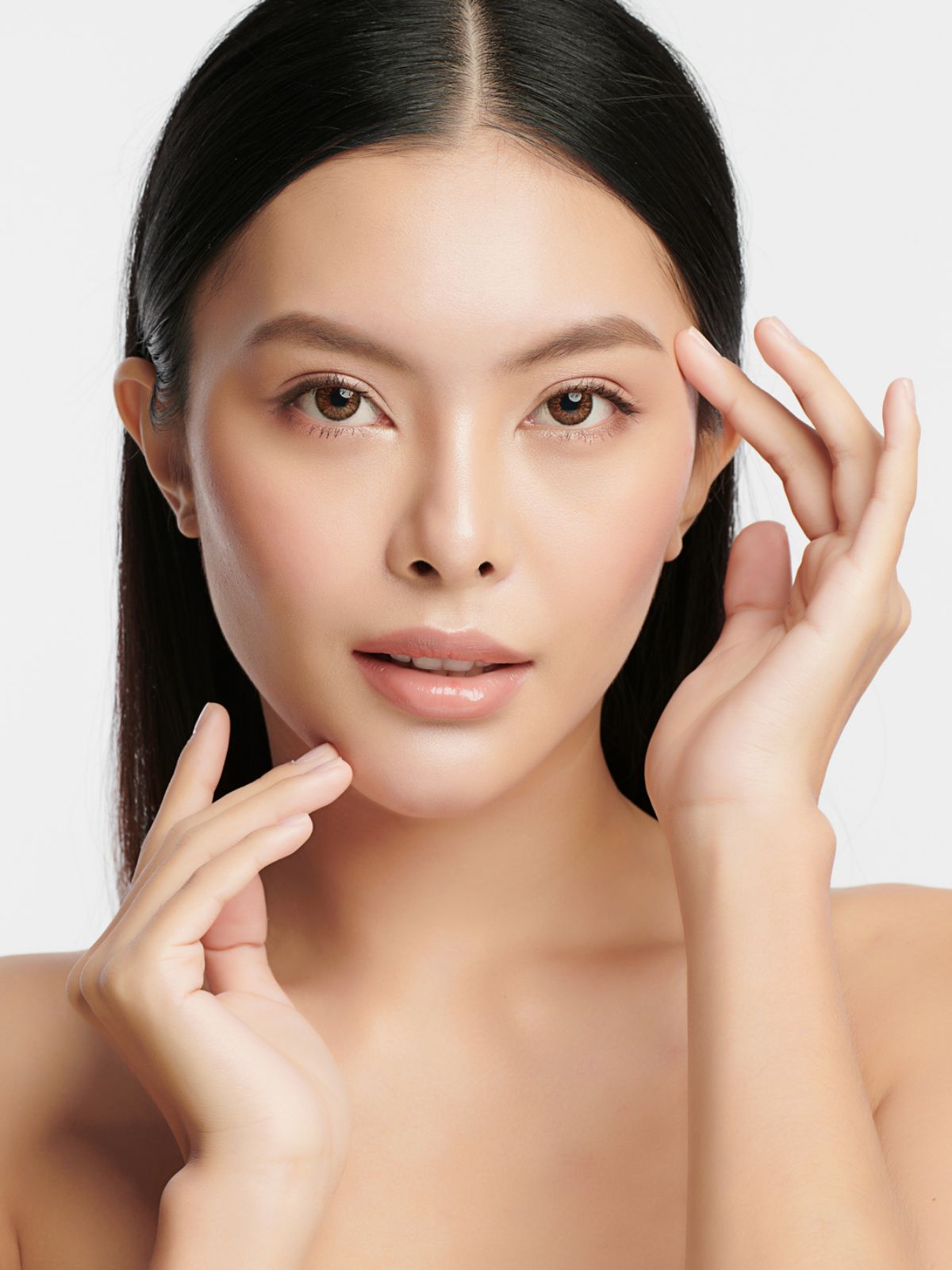 lovely asian woman touching the corner of her brow